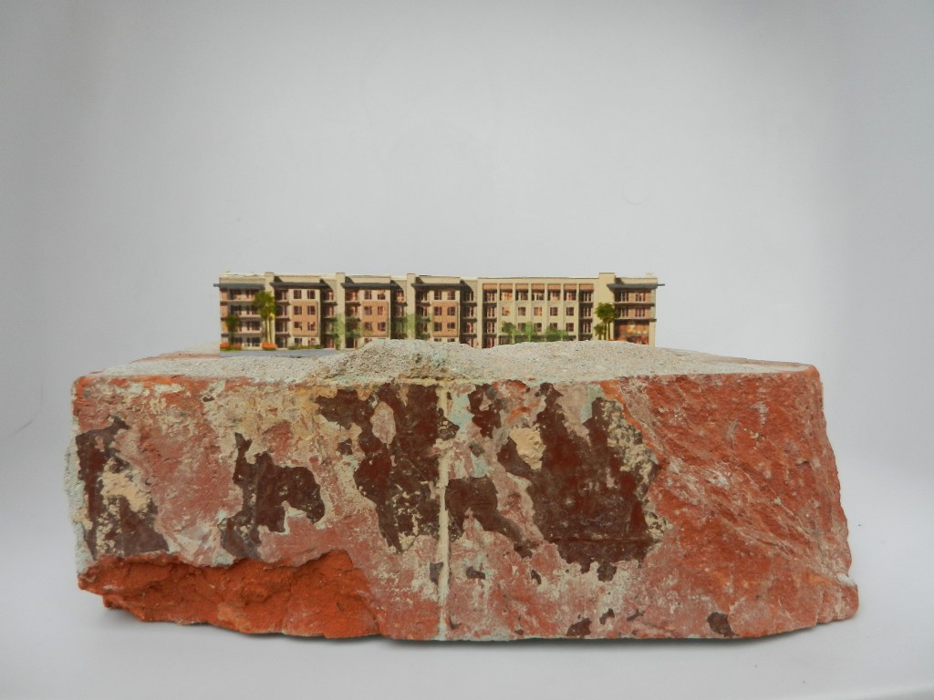 Mixed media artwork by Judith Dauncey, generic paper condo "installed" on a salvaged brick from the historic 307 club in downtown Phx