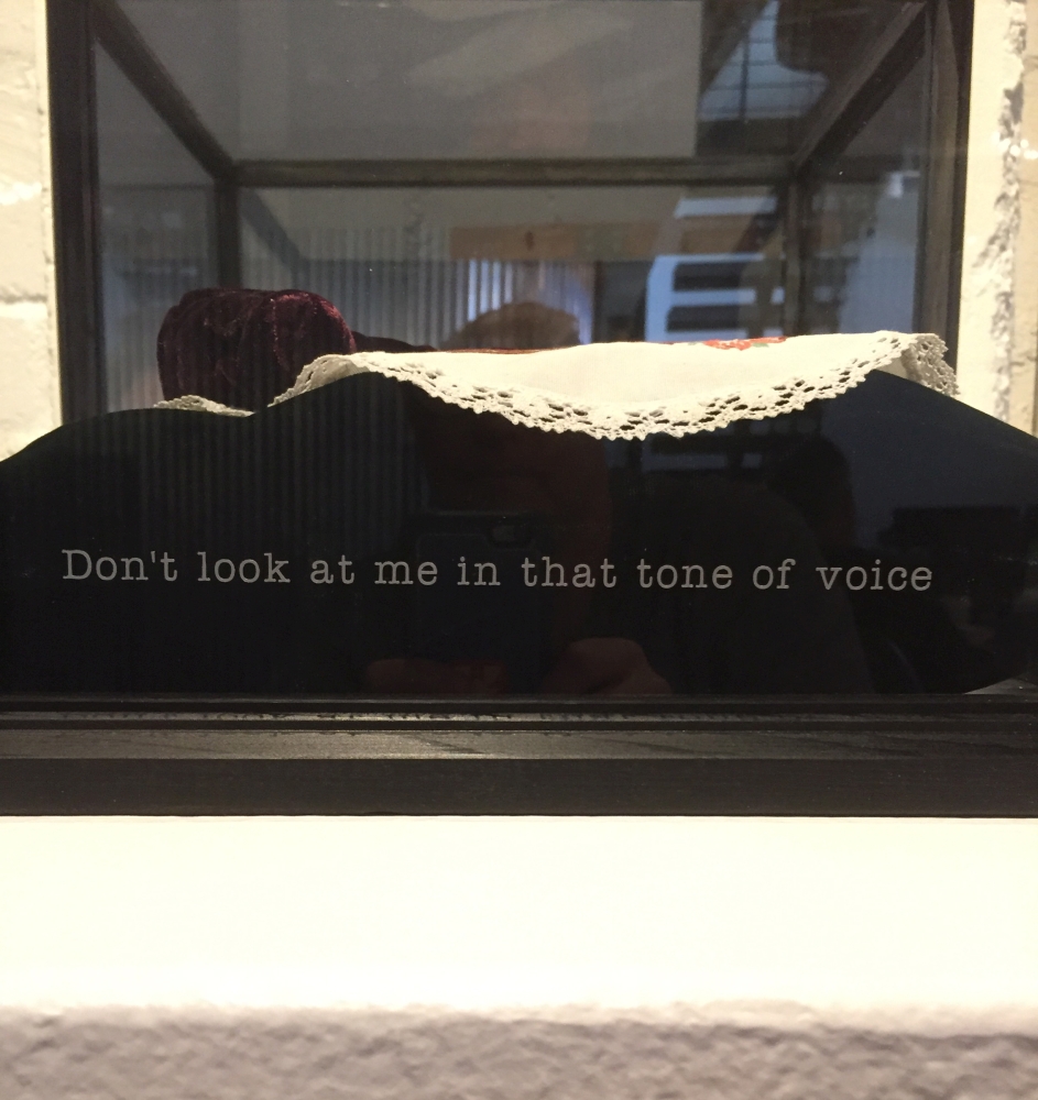 Original mixed media artwork by Judith Ann Miller, with a black velvet pillow, a red velvet hammer, vintage doilie, and a quote from poet Dorothy Parker